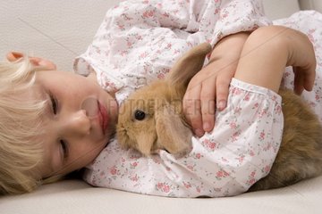 Child with small rabbit ram France