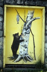 Painting of a door of hut representing a black bear Canada