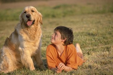 Golden retriever and child laid down in pre France