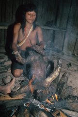 Matses woman burning hair of a Two-Toed Tree Sloth Peru