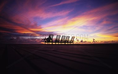 Woman in a deckchair on a pontoon at sunset Malaysia