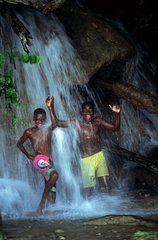 Children under a cascade Dunn's River Falls & Park Jamaica