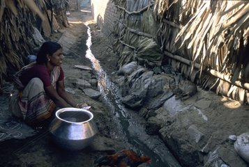 Cat and young woman near a gutter India