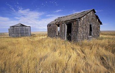 Old barn and wooden silos cylindrical Saskatchewan Canada