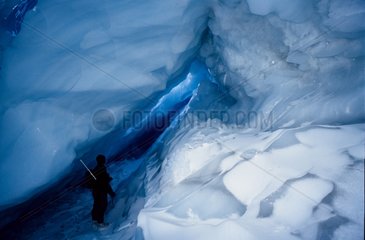Man discovering the interior of an iceberg in winter Arctic