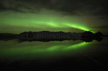 Aurora borealis reflecting on lake Joekulsárlón Iceland