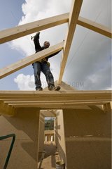 Laborer working on the roof of a house