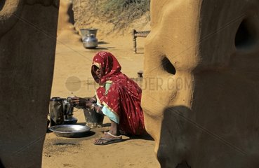 Young girl washing the dishes Shekewati India
