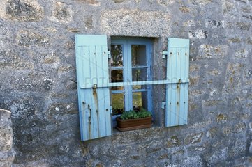 Fenestrate with blue shutters of a house in Brittany