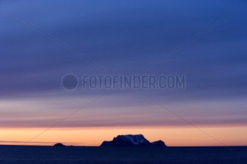 Silhouette of a coastal mountain at twilight Norway
