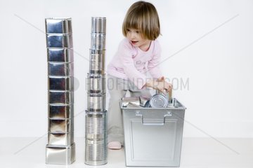 Girl playing with cans and sorting bin