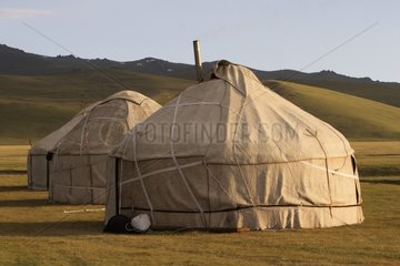 Three yurts near lake Son Kul at sunset Kyrgyzstan
