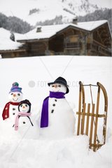 Family snowmen dressed for winter France