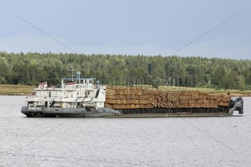 Boat carrying planks on a lake Russia