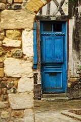 Blue door and stone wall in a lane with Honfleur