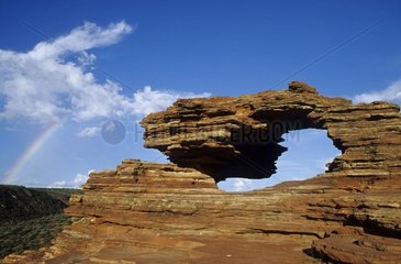 Fenêtre naturelle dans la roche et arc-en-ciel Australie
