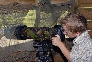 A boy watching with a telephoto shooting France