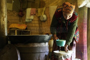 Woman filtering milk Son Kul Lake Naryn Kyrgyzstan