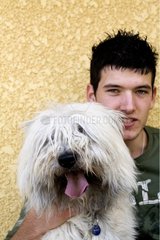 Portrait of a white dog with his owner