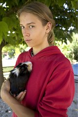 Teenager carrying a Guinea pig