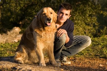 Portrait of a Dog Retriever Golden delicious with its Master