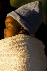 Baby sleeping in the back of her mother Zimbabwe