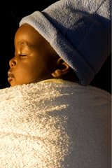 Baby sleeping in the back of her mother Zimbabwe