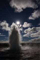 Strokkur geyser gushing in summer Iceland