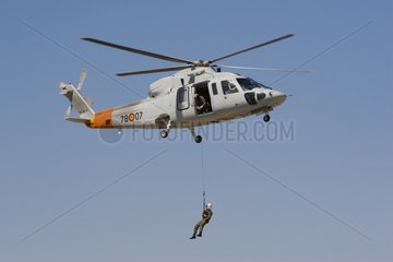 Person suspended to a helicopter hovering
