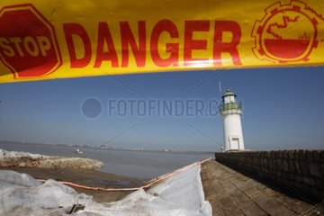 Cleaning of oil spill in banks of Loire river estuary France