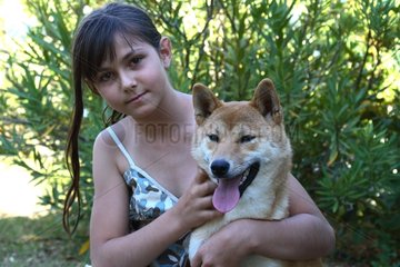 Portrait of a Girl and a Shiba Inu in a garden France
