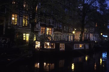 Houses near a canal at night in Amsterdam Holland