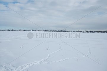 Village of Stari under snow at the edge of the lake Ladoga Russia