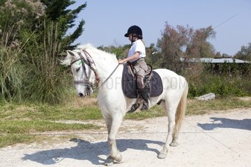 Young rider on his Camargue horse in the Camargue RNP