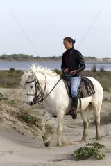 Rider on her Camargue horse in the Camargue RNP