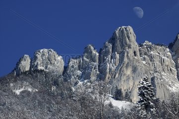 Moon in the blue sky of the snow-covered Massif des Bornes