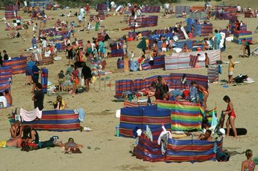 Crowds of holidaymakers on sand beach Padstow England