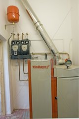Fired domestic biomass boiler produces heat Cotswolds UK