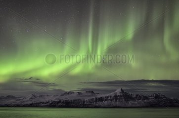 Aurora borealis above the Fjord Reyðarfjoerður - Iceland