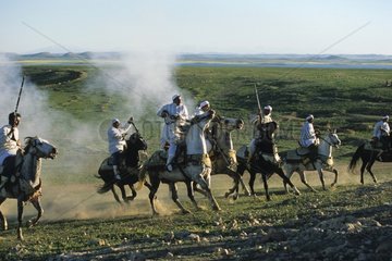 Horsemen riding in an equestrian fantasia in Morocco