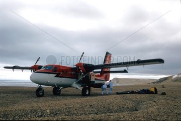 Men discharging material from the twin otter for expedition