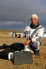 Man in the Arctic with a satellite phone