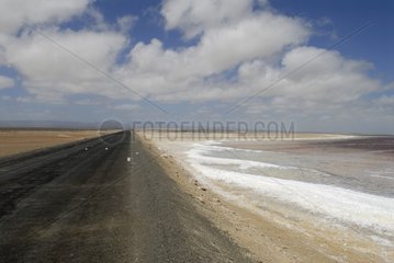 Road skirting saltworks in the desert of Vizcaino