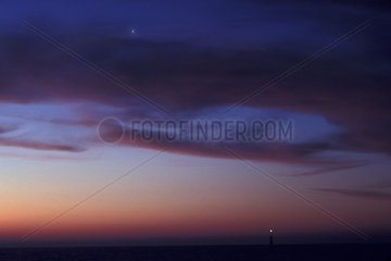 Venus above the sea and a headlight in the morning Ré Island