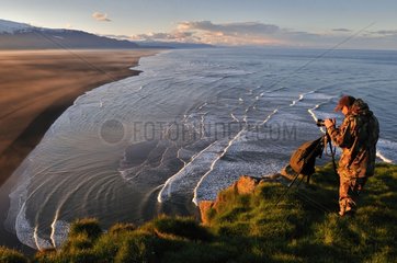 Photographer on the peninsula of Ingolfshoefoi Iceland