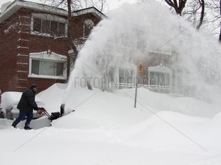 Man removing the snow in front of his house Quebec