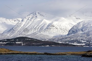 Snow-covered mountains on the coast of North Sea Norway