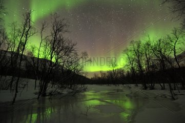 Aurora Borealis over a frozen river - Norway