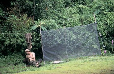 Naturalist sitting near an insect trap Panama