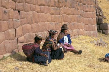 Frauen in traditioneller Kleidung drehen Wolle Peru